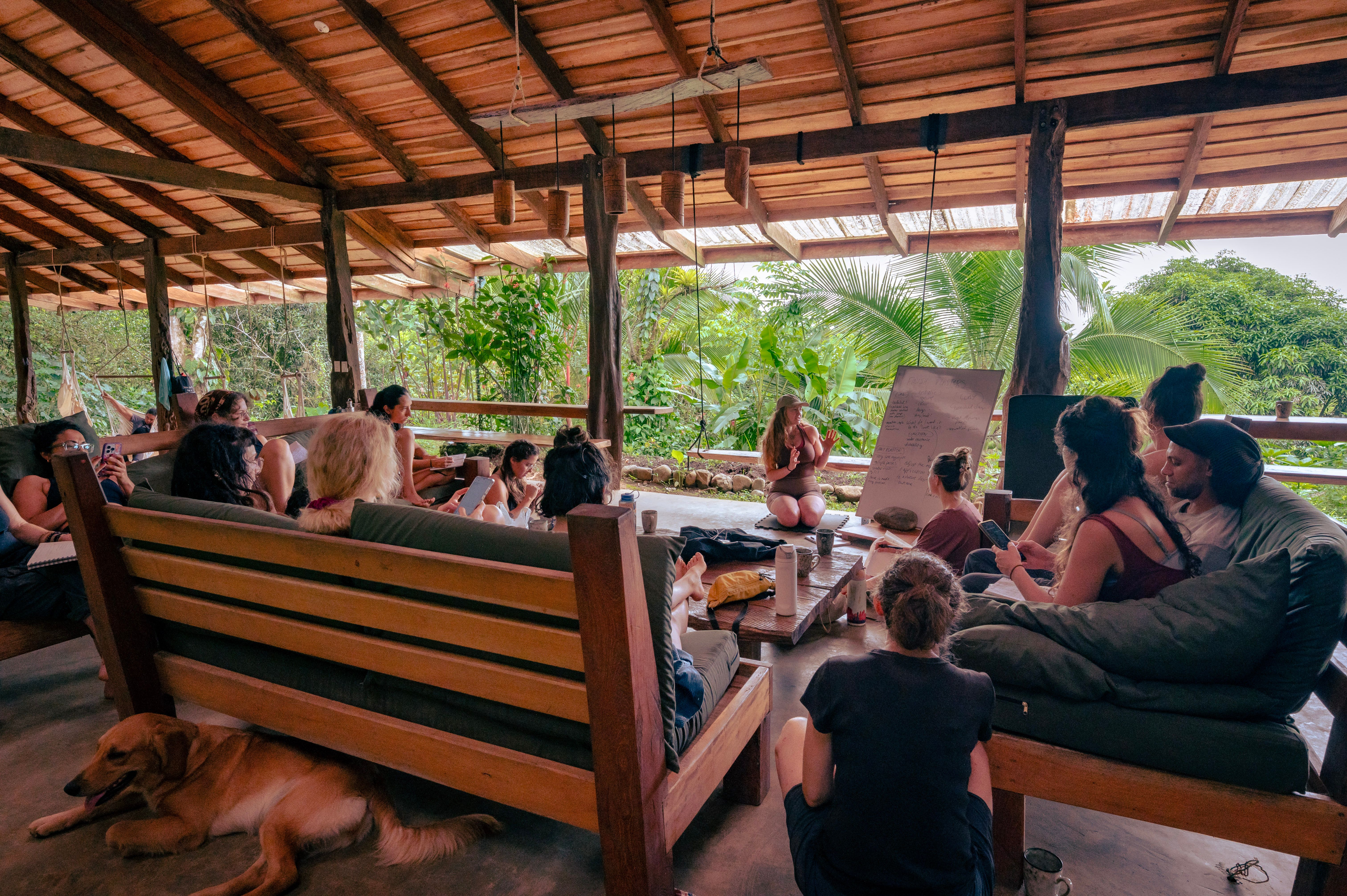 Residents relaxing together in an open air lounge at Protopia Community coliving in Costa Rica