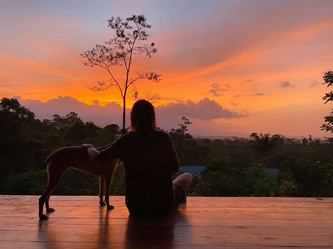 Sunset over the rainforest from the wooden deck at Protopia Community coliving in Costa Rica