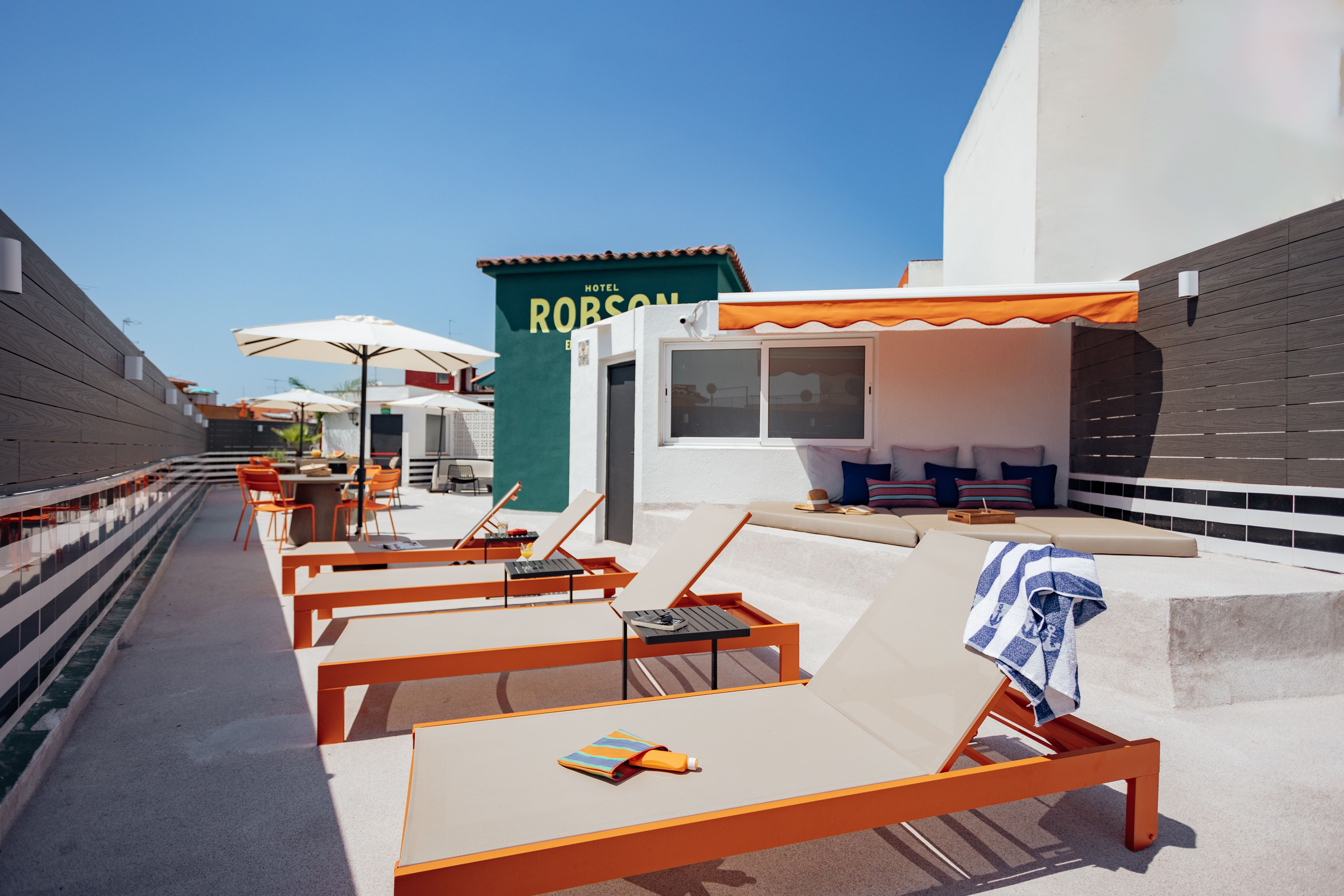 Rooftop terrace with sun loungers at The Better Neighbors workation in Lloret de Mar on the Costa Brava